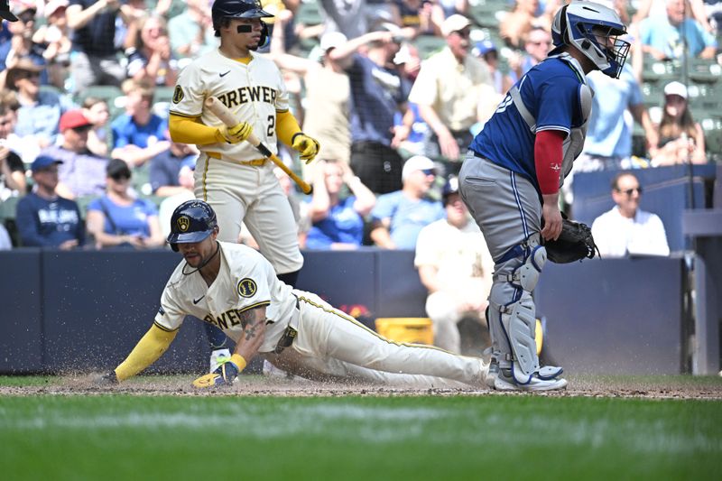 Jun 12, 2024; Milwaukee, Wisconsin, USA;  Milwaukee Brewers outfielder Blake Perkins (16) slides in for a run in the sixth inning against the Toronto Blue Jays at American Family Field. Mandatory Credit: Michael McLoone-USA TODAY Sports