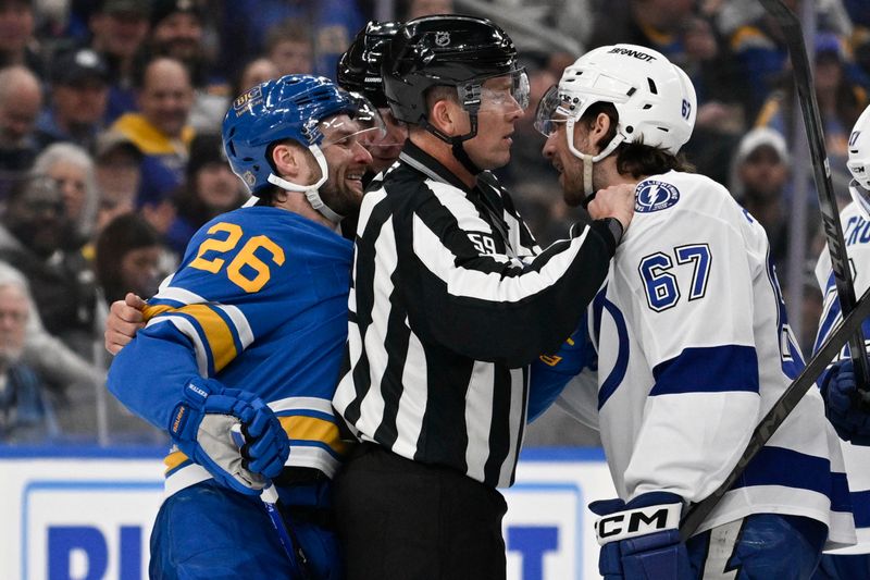 Jan 16, 2026; St. Louis, Missouri, USA; Tampa Bay Lightning defenseman Declan Carlile (67) and St. Louis Blues left wing Nathan Walker (26) get physical during the first period at Enterprise Center. Mandatory Credit: Jeff Le-Imagn Images