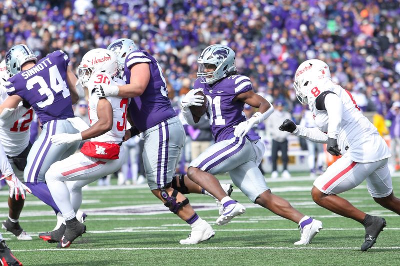 Oct 28, 2023; Manhattan, Kansas, USA; Kansas State Wildcats running back DJ Giddens (31) runs away from Houston Cougars linebacker Malik Robinson (8) during the third quarter at Bill Snyder Family Football Stadium. Mandatory Credit: Scott Sewell-USA TODAY Sports