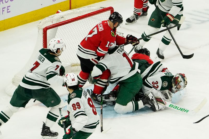 Jan 26, 2025; Chicago, Illinois, USA; Chicago Blackhawks left wing Nick Foligno (17) Minnesota Wild left wing Marcus Foligno (17) and Minnesota Wild goaltender Filip Gustavsson (32) crash into the goal during the third period at United Center. Mandatory Credit: David Banks-Imagn Images