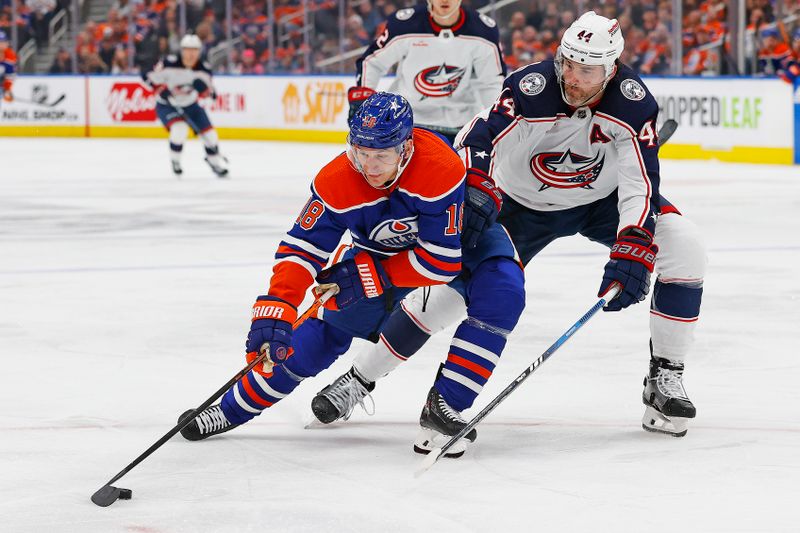 Jan 23, 2024; Edmonton, Alberta, CAN; Edmonton Oilers forward Zach Hyman (18) carries the puck around Columbus Blue Jackets defensemen Erik Gudbranson (44) during the third period at Rogers Place. Mandatory Credit: Perry Nelson-USA TODAY Sports