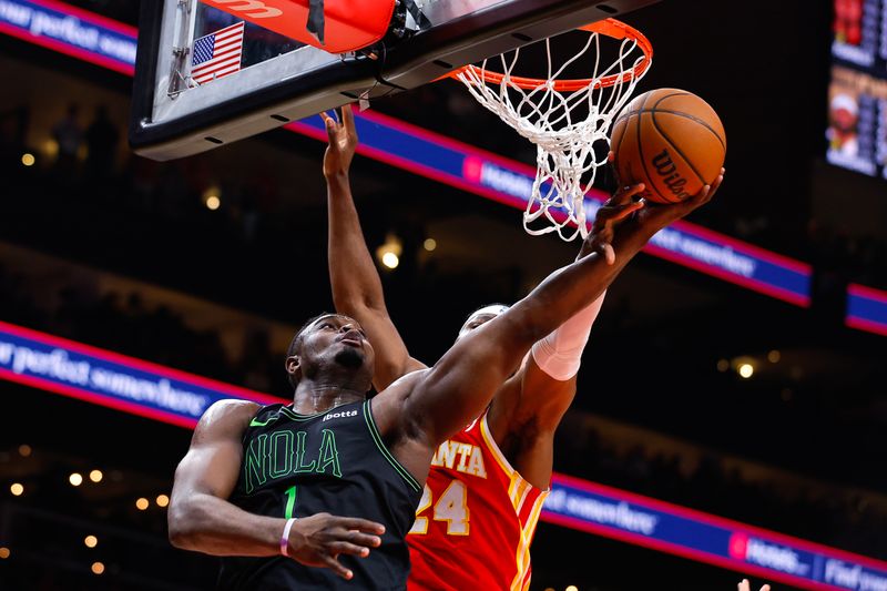 ATLANTA, GEORGIA - MARCH 10: Zion Williamson #1 of the New Orleans Pelicans goes up for a shot against Bruno Fernando #24 of the Atlanta Hawks during the fourth quarter at State Farm Arena on March 10, 2024 in Atlanta, Georgia. NOTE TO USER: User expressly acknowledges and agrees that, by downloading and or using this photograph, User is consenting to the terms and conditions of the Getty Images License Agreement. (Photo by Todd Kirkland/Getty Images)