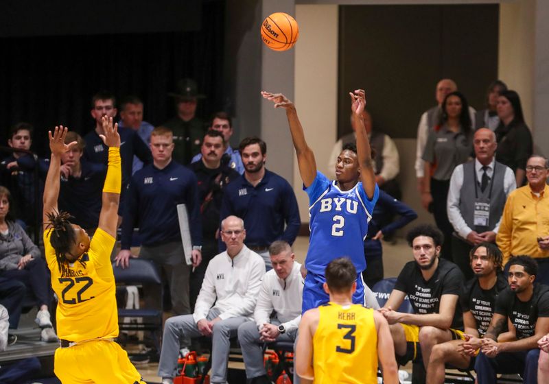 Feb 3, 2024; Morgantown, West Virginia, USA; Brigham Young Cougars guard Jaxson Robinson (2) shoots a three pointer over West Virginia Mountaineers forward Josiah Harris (22) during the first half at WVU Coliseum. Mandatory Credit: Ben Queen-USA TODAY Sports