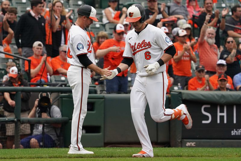 Sep 25, 2025; Baltimore, Maryland, USA; Baltimore Orioles designated hitter Ryan Mountcastle (6) greeted by coach Buck Britton (46) following his solo home run in the third inning against the Tampa Bay Rays at Oriole Park at Camden Yards. Mandatory Credit: Mitch Stringer-Imagn Images