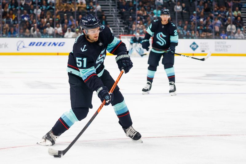 Oct 1, 2022; Seattle, Washington, USA; Seattle Kraken center Shane Wright (51) shoots the puck against the Vancouver Canucks during the first period at Climate Pledge Arena. Mandatory Credit: Joe Nicholson-USA TODAY Sports