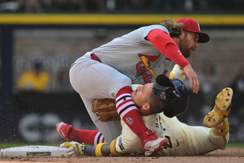 Sep 2, 2024; Milwaukee, Wisconsin, USA; St. Louis Cardinals second baseman Brendan Donovan (33) tags out Milwaukee Brewers third baseman Joseph Ortiz (3) trying to stretch a single into a double in the fourth inning at American Family Field. Mandatory Credit: Benny Sieu-USA TODAY Sports