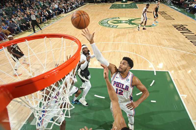 MILWAUKEE, WI - MARCH 14: Tobias Harris #12 of the Philadelphia 76ers rebounds during the game against the Milwaukee Bucks on March 14, 2024 at the Fiserv Forum Center in Milwaukee, Wisconsin. NOTE TO USER: User expressly acknowledges and agrees that, by downloading and or using this Photograph, user is consenting to the terms and conditions of the Getty Images License Agreement. Mandatory Copyright Notice: Copyright 2024 NBAE (Photo by Gary Dineen/NBAE via Getty Images).