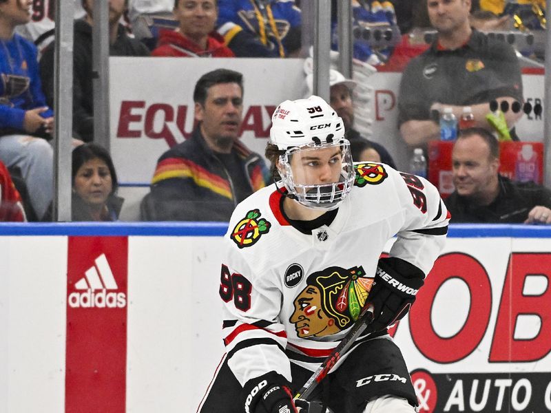 Apr 10, 2024; St. Louis, Missouri, USA;  Chicago Blackhawks center Connor Bedard (98) controls the puck against the St. Louis Blues during the third period at Enterprise Center. Mandatory Credit: Jeff Curry-USA TODAY Sports