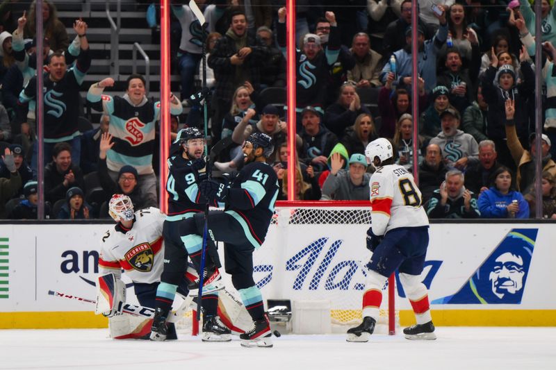 Dec 12, 2023; Seattle, Washington, USA; Seattle Kraken center Devin Shore (94) and left wing Pierre-Edouard Bellemare (41) celebrate after Bellemare scored a goal against the Florida Panthers during the third period at Climate Pledge Arena. Mandatory Credit: Steven Bisig-USA TODAY Sports