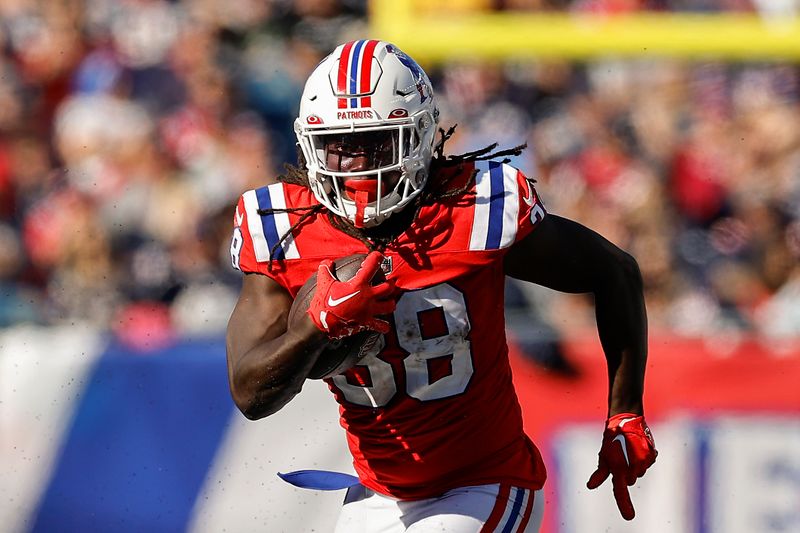 New England Patriots' Rhamondre Stevenson runs against the Detroit Lions during an NFL football game at Gillette Stadium, Sunday, Oct. 9, 2022 in Foxborough, Mass. (Winslow Townson/AP Images for Panini)