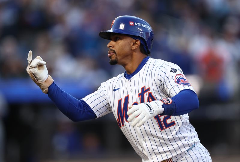 Oct 18, 2024; New York City, New York, USA; 
New York Mets shortstop Francisco Lindor (12) hits a single during the first inning against the Los Angeles Dodgers during game five of the NLCS for the 2024 MLB playoffs at Citi Field. Mandatory Credit: Vincent Carchietta-Imagn Images