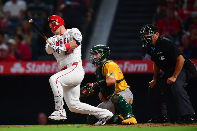 Sep 6, 2025; Anaheim, California, USA; Los Angeles Angels designated hitter Mike Trout (27) hits a single against the Athletics during the third inning at Angel Stadium. Mandatory Credit: Gary A. Vasquez-Imagn Images