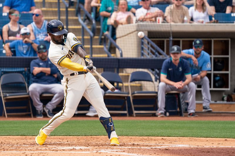 Mar 26, 2022; Phoenix, Arizona, USA; Milwaukee Brewers outfielder Andrew McCutchen (24) hits a home run against the Seattle Mariners in the third inning during a spring training game at American Family Fields of Phoenix. Mandatory Credit: Allan Henry-USA TODAY Sports