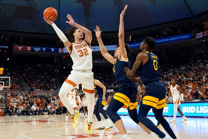 Feb 11, 2023; Austin, Texas, USA; Texas Longhorns forward Christian Bishop (32) shoots over West Virginia Mountaineers forward James Okonkwo (32) and guard Kedrian Johnson (0) during the first half at Moody Center. Mandatory Credit: Scott Wachter-USA TODAY Sports