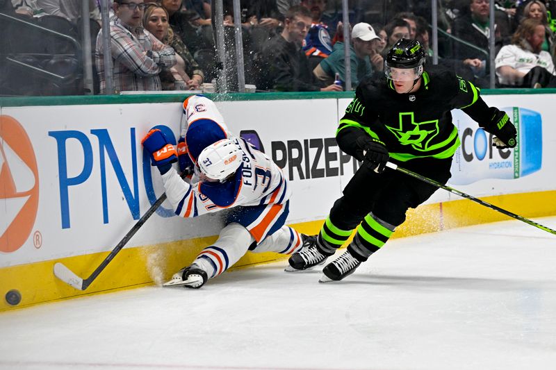 Apr 3, 2024; Dallas, Texas, USA; Edmonton Oilers left wing Warren Foegele (37) crashes into the boards as Foegele  and Dallas Stars defenseman Ryan Suter (20) chase the puck in the Stars zone during the third period at the American Airlines Center. Mandatory Credit: Jerome Miron-USA TODAY Sports