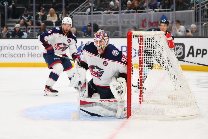 Nov 12, 2024; Seattle, Washington, USA; Columbus Blue Jackets goaltender Elvis Merzlikins (90) defends the goal against the Seattle Kraken during the third period at Climate Pledge Arena. Mandatory Credit: Steven Bisig-Imagn Images