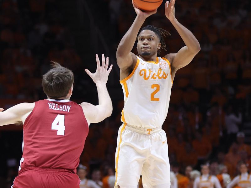 Mar 1, 2025; Knoxville, Tennessee, USA; Tennessee Volunteers guard Chaz Lanier (2) shoots the ball against Alabama Crimson Tide forward Grant Nelson (4) during the first half at Thompson-Boling Arena at Food City Center. Mandatory Credit: Randy Sartin-Imagn Images