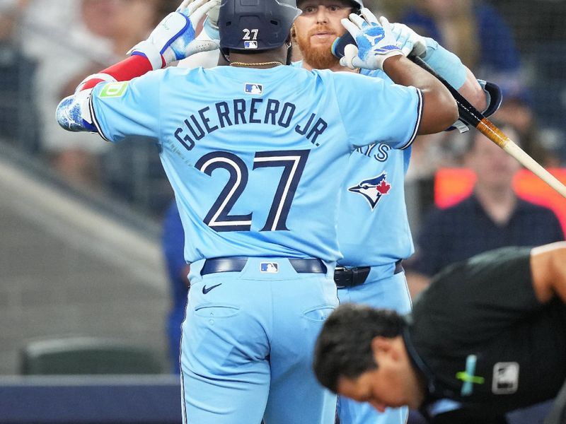 Jul 23, 2024; Toronto, Ontario, CAN; Toronto Blue Jays first base Vladimir Guerrero Jr. (27) hits a home run and celebrates with designated hitter Justin Turner (2) against the Tampa Bay Rays during the sixth inning at Rogers Centre. Mandatory Credit: Nick Turchiaro-USA TODAY Sports