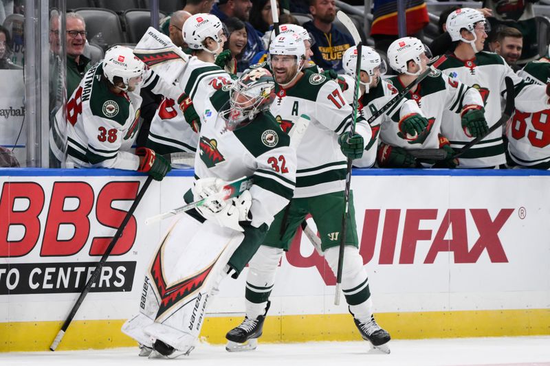 Oct 15, 2024; St. Louis, Missouri, USA; Minnesota Wild goaltender Filip Gustavsson (32) is congratulated by teammates after scoring a goal against the St. Louis Blues during the third period at Enterprise Center. Mandatory Credit: Jeff Le-Imagn Images