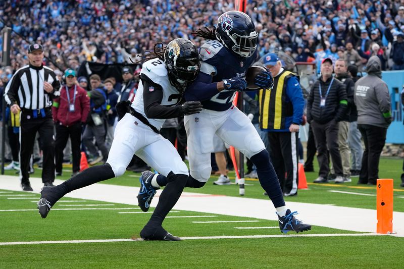 Tennessee Titans running back Derrick Henry (22) runs for a touchdown against Jacksonville Jaguars safety Rayshawn Jenkins (2) during the first half of an NFL football game Sunday, Jan. 7, 2024, in Nashville, Tenn. (AP Photo/George Walker IV)