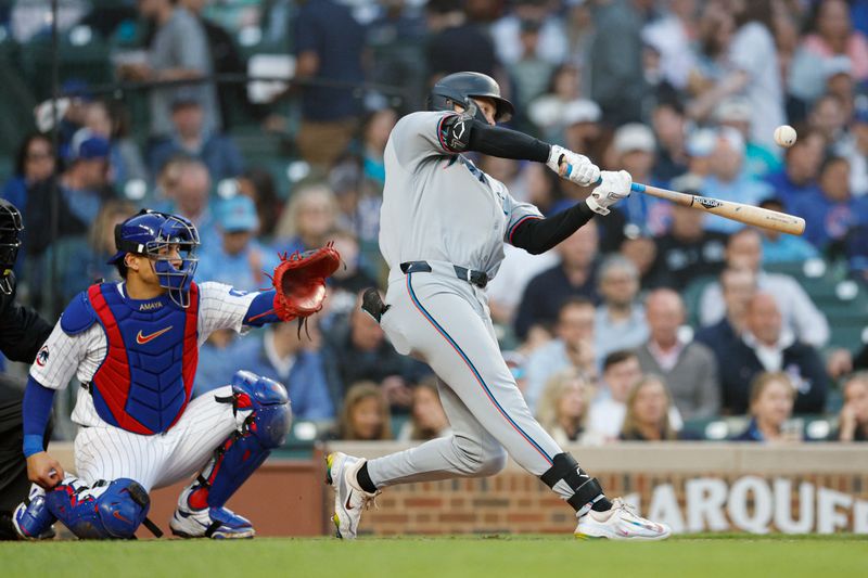 May 14, 2025; Chicago, Illinois, USA; Miami Marlins center fielder Kyle Stowers (28) hits a solo home run against the Chicago Cubs during the fourth inning at Wrigley Field. Mandatory Credit: Kamil Krzaczynski-Imagn Images