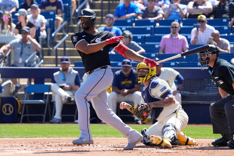 Mar 13, 2024; Phoenix, Arizona, USA; Chicago White Sox Eloy Jimenez (74) hits a two run double against the Milwaukee Brewers in the first inning at American Family Fields of Phoenix. Mandatory Credit: Rick Scuteri-USA TODAY Sports