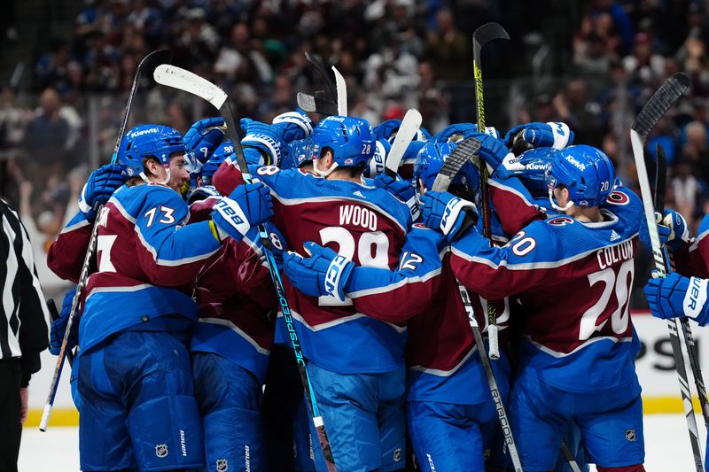 Mar 24, 2024; Denver, Colorado, USA; Members of the Colorado Avalanche celebrate an overtime win against the Pittsburgh Penguins at Ball Arena. Mandatory Credit: Ron Chenoy-USA TODAY Sports