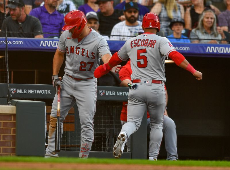 Jun 24, 2023; Denver, Colorado, USA; Los Angeles Angels center fielder Mike Trout (27) slaps the hand of Los Angeles Angels third baseman Eduardo Escobar (5) after scoring in the third inning against the Colorado Rockies at Coors Field. Mandatory Credit: John Leyba-USA TODAY Sports