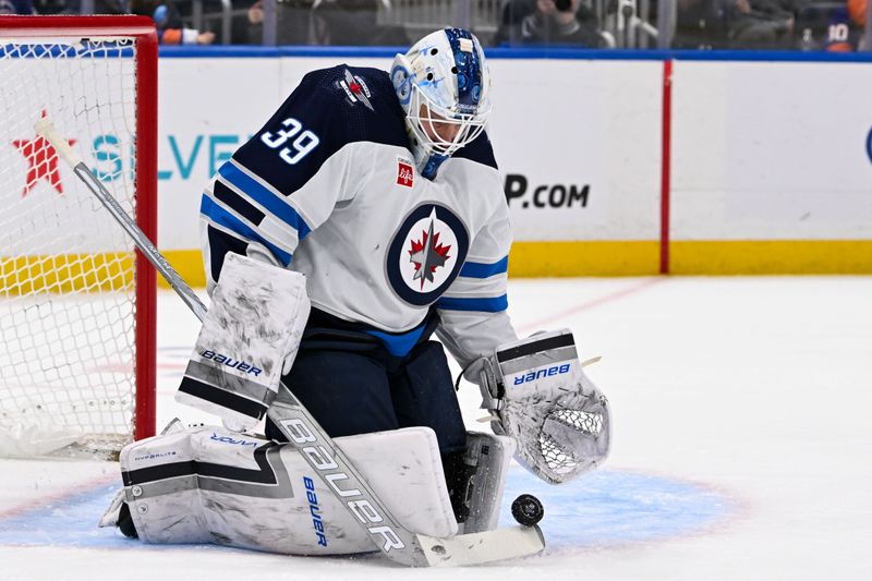 Mar 23, 2024; Elmont, New York, USA;  Winnipeg Jets goaltender Laurent Brossoit (39) makes a save against the New York Islanders during the second period at UBS Arena. Mandatory Credit: Dennis Schneidler-USA TODAY Sports