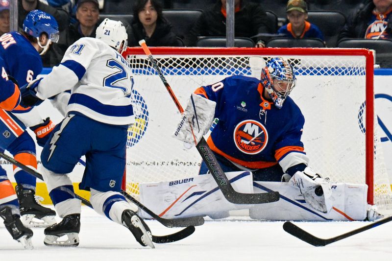 Dec 13, 2025; Elmont, New York, USA; New York Islanders goaltender Ilya Sorokin (30) makes a save on Tampa Bay Lightning center Brayden Point (21) during the second period at UBS Arena. Mandatory Credit: Dennis Schneidler-Imagn Images