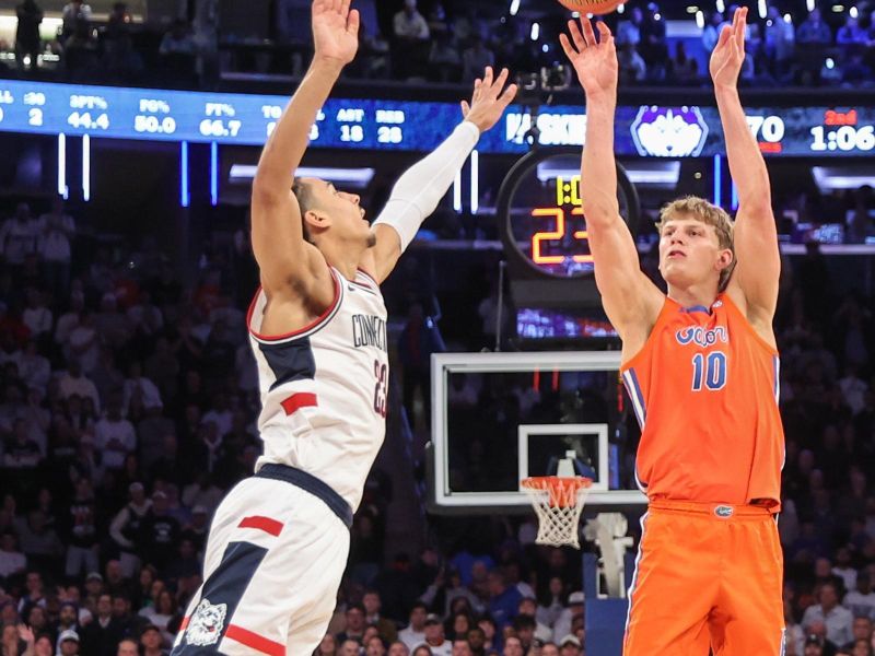 Dec 9, 2025; New York, New York, USA;  Florida Gators forward Thomas Haugh (10) shoots past UConn Huskies forward Jayden Ross (23) in the second half at Madison Square Garden. Mandatory Credit: Wendell Cruz-Imagn Images