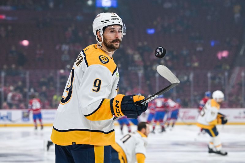 Dec 10, 2023; Montreal, Quebec, CAN; Nashville Predators left wing Filip Forsberg (9) plays with a puck during warm-up before the game against the Montreal Canadiens at Bell Centre. Mandatory Credit: David Kirouac-USA TODAY Sports