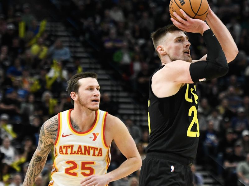 SALT LAKE CITY, UTAH - MARCH 15: Micah Potter #25 of the Utah Jazz shoots over Garrison Mathews #25 of the Atlanta Hawks during the second half of a game at Delta Center on March 15, 2024 in Salt Lake City, Utah.  NOTE TO USER: User expressly acknowledges and agrees that, by downloading and or using this photograph, User is consenting to the terms and conditions of the Getty Images License Agreement.  (Photo by Alex Goodlett/Getty Images)