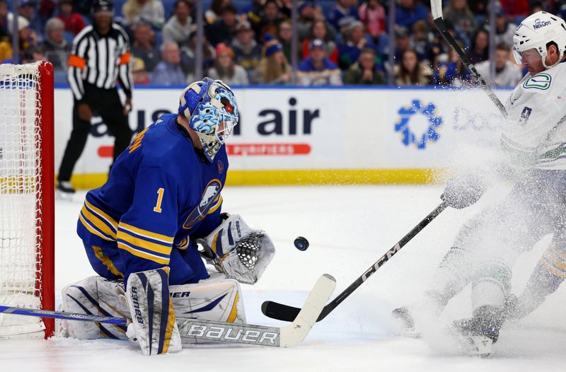 Jan 13, 2024; Buffalo, New York, USA;  Buffalo Sabres goaltender Ukko-Pekka Luukkonen (1) looks to make a save as Vancouver Canucks center J.T. Miller (9) waits for a rebound during the third period at KeyBank Center. Mandatory Credit: Timothy T. Ludwig-USA TODAY Sports