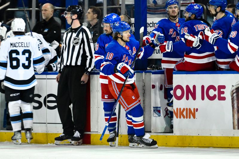 Oct 12, 2024; New York, New York, USA; New York Rangers left wing Artemi Panarin (10) celebrates with teammates after scoring a goal against the Utah Hockey Club during the first period at Madison Square Garden. Mandatory Credit: John Jones-Imagn Images