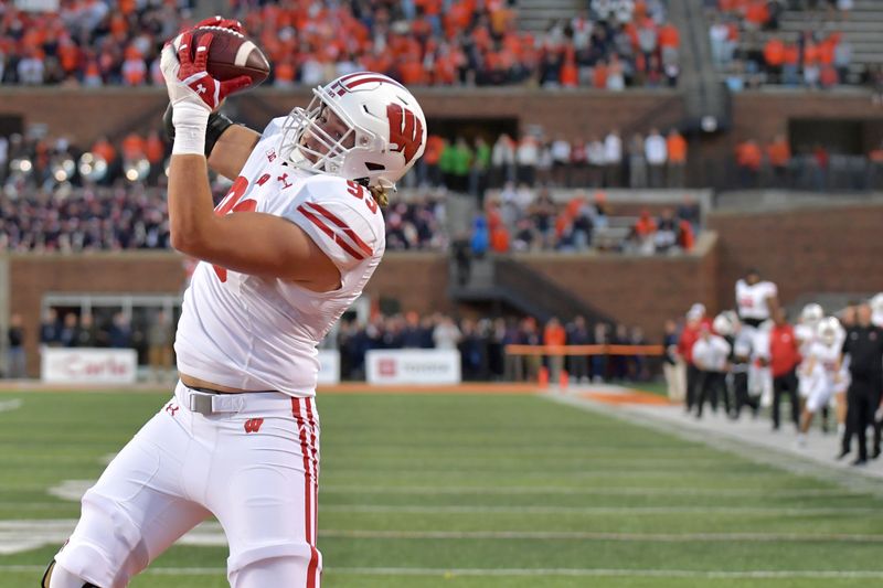 Oct 21, 2023; Champaign, Illinois, USA;  Wisconsin Badgers defensive end Isaac Townsend (93) catches a touchdown during the second half against the Illinois Fighting Illini at Memorial Stadium. Mandatory Credit: Ron Johnson-USA TODAY Sports