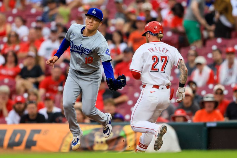 May 26, 2024; Cincinnati, Ohio, USA; Los Angeles Dodgers starting pitcher Yoshinobu Yamamoto (18) attempts to tag Cincinnati Reds outfielder Jake Fraley (27) out at first in the fifth inning at Great American Ball Park. Mandatory Credit: Katie Stratman-USA TODAY Sports