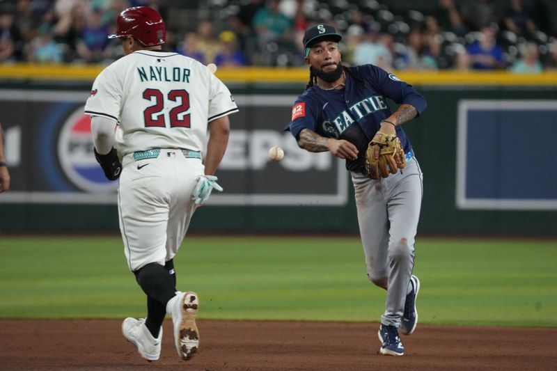Jun 9, 2025; Phoenix, Arizona, USA; Seattle Mariners shortstop J.P. Crawford (3) turns the double play while avoiding Arizona Diamondbacks fourth base Josh Naylor (22) in the first inning at Chase Field. Mandatory Credit: Rick Scuteri-Imagn Images
