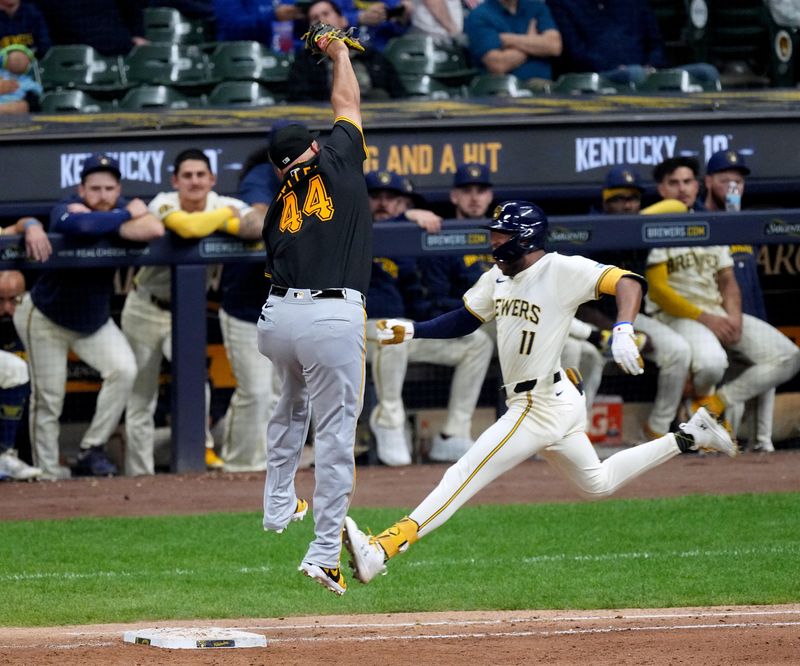 May 13, 2024; Milwaukee, Wisconsin, USA;  Milwaukee Brewers outfielder Jackson Chourio (11) beats a throw to Pittsburgh Pirates first base Rowdy Tellez (44) on a fielder’s choice during the fifth inning at American Family Field. Mandatory Credit: Mark Hoffman-USA TODAY Sports