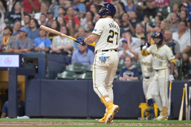 Jul 29, 2024; Milwaukee, Wisconsin, USA; Milwaukee Brewers shortstop Willy Adames (27) watches his home run against the Atlanta Braves in the sixth inning at American Family Field. Mandatory Credit: Michael McLoone-USA TODAY Sports