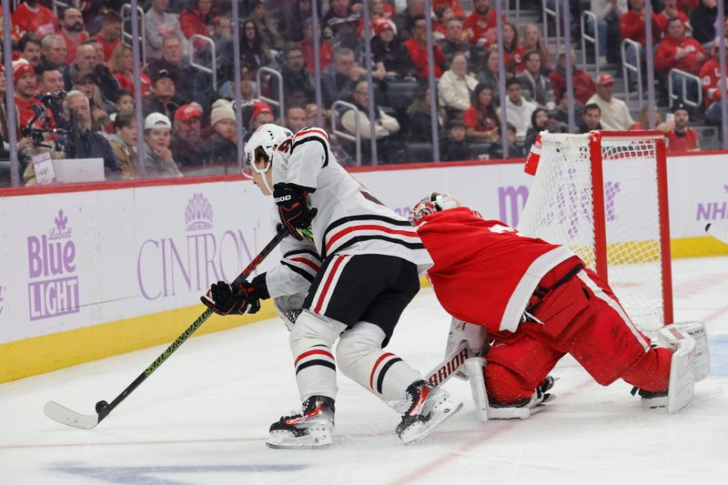 Nov 30, 2023; Detroit, Michigan, USA;  Chicago Blackhawks center Connor Bedard (98) skates with the puck around Detroit Red Wings goaltender Alex Lyon (34) in the first period at Little Caesars Arena. Mandatory Credit: Rick Osentoski-USA TODAY Sports