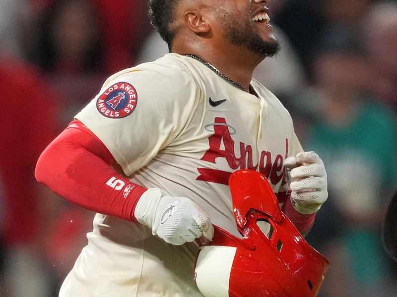 Jul 12, 2024; Anaheim, California, USA; Los Angeles Angels designated hitter Willie Calhoun (5) celebrates after hitting a two-run walkoff home run in the tenth inning against the Seattle Mariners at Angel Stadium. Mandatory Credit: Kirby Lee-USA TODAY Sports