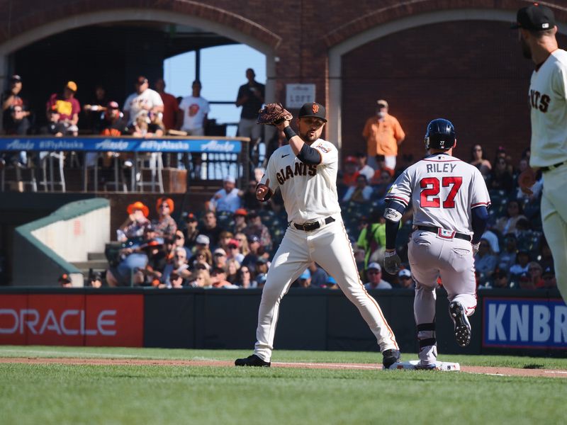 Aug 27, 2023; San Francisco, California, USA; San Francisco Giants first baseman J.D. Davis (7) catches the throw from starting pitcher Tristan Beck (43) for an out against Atlanta Braves third baseman Austin Riley (27) during the first inning at Oracle Park. Mandatory Credit: Kelley L Cox-USA TODAY Sports