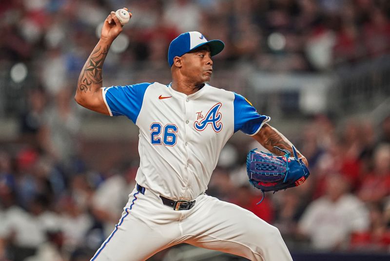 Jul 6, 2024; Cumberland, Georgia, USA; Atlanta Braves pitcher Raisel Iglesias (26) pitches against the Philadelphia Phillies during the ninth inning at Truist Park. Mandatory Credit: Dale Zanine-USA TODAY Sports
