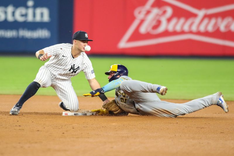 Sep 8, 2023; Bronx, New York, USA;  New York Yankees shortstop Anthony Volpe (11) is unable to hold onto the ball during a stolen base attempt by Milwaukee Brewers catcher William Contreras (24) in the seventh inning  at Yankee Stadium. Mandatory Credit: Wendell Cruz-USA TODAY Sports