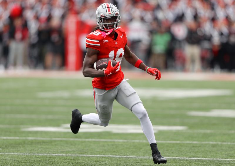 Oct 21, 2023; Columbus, Ohio, USA;  Ohio State Buckeyes wide receiver Marvin Harrison Jr. (18) runs after a catch against the Penn State Nittany Lions during the second quarter at Ohio Stadium. Mandatory Credit: Joseph Maiorana-USA TODAY Sports