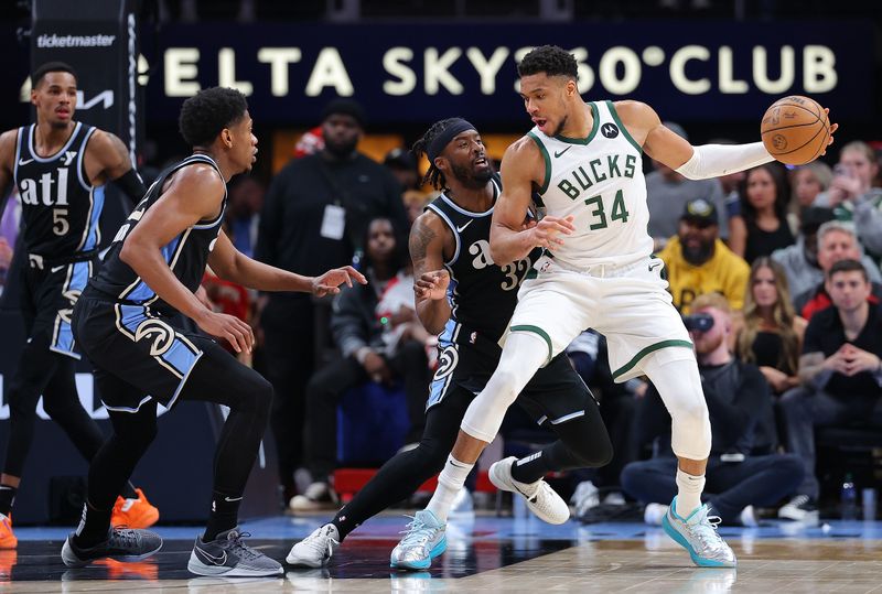 ATLANTA, GEORGIA - MARCH 30:  Giannis Antetokounmpo #34 of the Milwaukee Bucks drives against Wesley Matthews #32 and De'Andre Hunter #12 of the Atlanta Hawks during the third quarter at State Farm Arena on March 30, 2024 in Atlanta, Georgia.  NOTE TO USER: User expressly acknowledges and agrees that, by downloading and/or using this photograph, user is consenting to the terms and conditions of the Getty Images License Agreement.  (Photo by Kevin C. Cox/Getty Images)