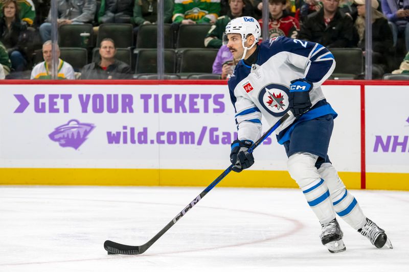 Nov 25, 2024; Saint Paul, Minnesota, USA;  Winnipeg Jets defenseman Dylan DeMelo (2) controls the puck against the Minnesota Wild during the second period at Xcel Energy Center. Mandatory Credit: Nick Wosika-Imagn Images