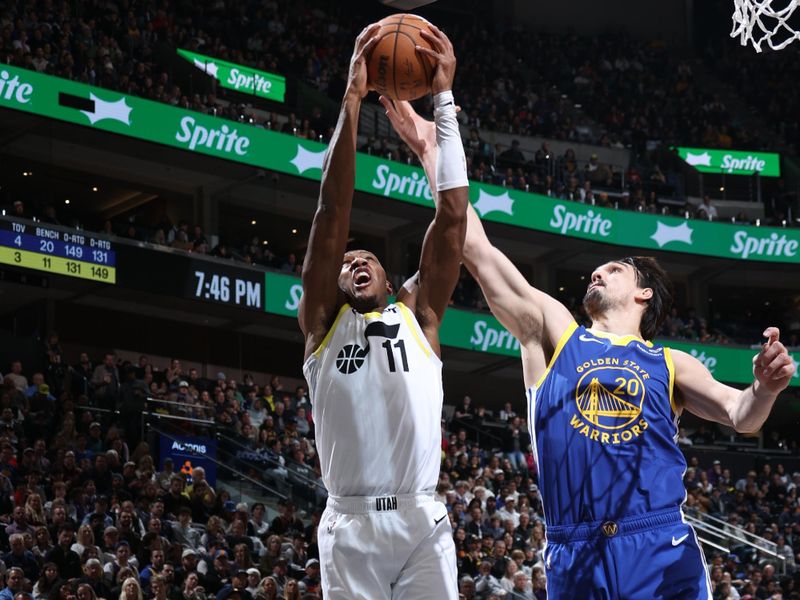 SALT LAKE CITY, UT - FEBRUARY 15: Kris Dunn #11 of the Utah Jazz grabs the rebound during the game against the Golden State Warriors on February 15, 2024 at Delta Center in Salt Lake City, Utah. NOTE TO USER: User expressly acknowledges and agrees that, by downloading and or using this Photograph, User is consenting to the terms and conditions of the Getty Images License Agreement. Mandatory Copyright Notice: Copyright 2024 NBAE (Photo by Melissa Majchrzak/NBAE via Getty Images)