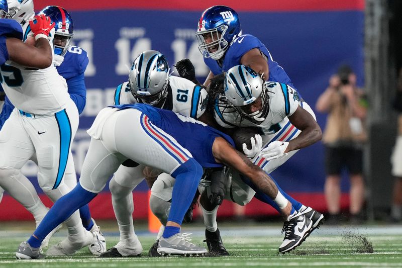 Carolina Panthers' Spencer Brown, right, is tackled bye New York Giants defenders during the second half of an NFL preseason football game, Friday, Aug. 18, 2023, in East Rutherford, N.J. (AP Photo/Bryan Woolston)